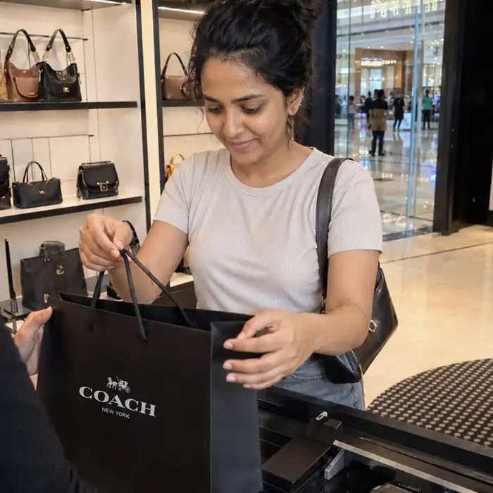 A woman alone with shopping bags, representing Rutvi's quietly growing debt