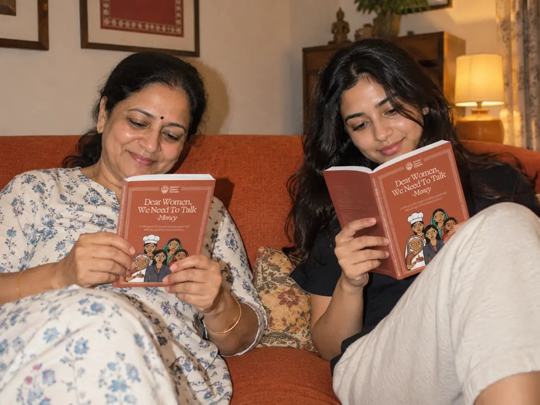 A mother and daughter reading the women’s finance handbook